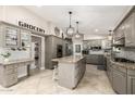 Spacious kitchen featuring granite countertops, pendant lighting, and stainless steel appliances at 253 N Fraser Dr, Mesa, AZ 85203