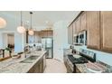 Well-equipped kitchen with stainless steel appliances, granite countertops, and ample cabinet space, perfect for cooking at 2877 E Lucky Horseshoe Ln, San Tan Valley, AZ 85140