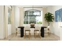 Bright dining room features modern lighting, large window, and seating for six at 2897 E Lucky Horseshoe Ln, San Tan Valley, AZ 85140