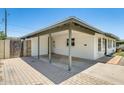 Covered carport with brick pavers, white brick walls, and a view of the front yard at 3001 N 21St Ave, Phoenix, AZ 85015
