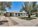 Inviting single-story home with a covered carport and a well-maintained front yard at 3001 N 21St Ave, Phoenix, AZ 85015