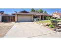 Well-kept single-story home with a spacious driveway and a two-car garage at 3009 W Christy Dr, Phoenix, AZ 85029