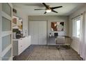 Bright home office featuring a modern desk, stylish decor, and a ceiling fan for added comfort at 3009 W Christy Dr, Phoenix, AZ 85029