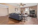 Cozy living room featuring tiled flooring, comfortable seating, and natural light from the windows at 4556 W Cholla St, Glendale, AZ 85304