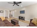 Open-concept living room featuring neutral paint, ceiling fan, and ample space for entertaining guests at 5808 S 12Th Ln, Phoenix, AZ 85041