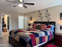 Spacious main bedroom featuring a ceiling fan, ensuite bath, and ample closet space at 6049 S Wilson Dr, Chandler, AZ 85249