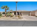 Charming home with a well-manicured yard, palm trees, and a spacious two-car garage at 6131 S Bradshaw Way, Chandler, AZ 85249