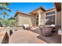 Inviting front porch with wicker furniture, stone accents, and an attractive entrance at 6131 S Bradshaw Way, Chandler, AZ 85249