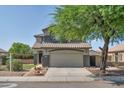 Inviting home with a two-car garage and desert landscaping, offering curb appeal at 6321 W Gross Ave, Phoenix, AZ 85043