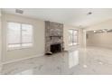 Living room with two windows, fireplace, and white marble floors at 643 W Medina Ave, Mesa, AZ 85210