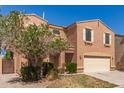 Charming two-story home with an attached two-car garage, complemented by a mature shade tree in the front yard at 7029 S Golfside Ln, Phoenix, AZ 85042