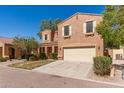 Attractive two-story home with a two-car garage, enhanced by well-maintained landscaping and desert surroundings at 7029 S Golfside Ln, Phoenix, AZ 85042