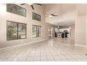 Bright, open living space with soaring ceilings, clerestory windows, and neutral tile flooring at 7029 S Golfside Ln, Phoenix, AZ 85042