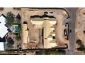 Aerial view of a single-story home under construction, displaying the expansive roof and surrounding desert landscape at 7620 E Paradise Dr, Scottsdale, AZ 85260
