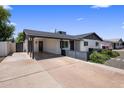 This beautiful home offers a carport, white exterior, and covered entry, enhancing curb appeal and functionality at 7707 E Earll Dr, Scottsdale, AZ 85251