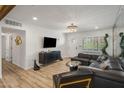 Elegant living room featuring a modern chandelier, comfortable leather seating, and stylish decor at 7707 E Earll Dr, Scottsdale, AZ 85251