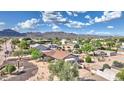 Expansive desert home featuring a low-pitched roof and mature native trees at 833 N 110Th St, Mesa, AZ 85207