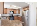 Efficient kitchen featuring stainless steel appliances, wood cabinets and a skylight at 925 S Longmore -- # 201, Mesa, AZ 85202