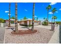 Beautiful front exterior view of single-story home with mature trees, manicured landscape, and a spacious driveway at 9654 E Foster Ave, Sun Lakes, AZ 85248