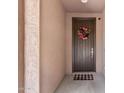 Warm entryway featuring a wood front door adorned with a colorful wreath and a welcome mat at 974 W Zion Way, Chandler, AZ 85248