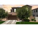 Beautiful two-story house featuring a two-car garage, maintained lawn, and lovely mature trees at 974 W Zion Way, Chandler, AZ 85248