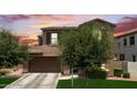 Lovely home boasts a two-car garage, complemented by a well-kept lawn, and mature trees at 974 W Zion Way, Chandler, AZ 85248