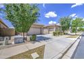 Street view of a lovely home featuring two-car garage, desert landscaping, and tiled roof at 9845 E Thistle Ave, Mesa, AZ 85212