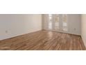 Clean bedroom showcasing wood-look floors and natural light through large windows at 9929 W Thunderbird Blvd, Sun City, AZ 85351