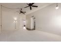 Bright living room with neutral carpet, vaulted ceilings, decorative lighting and updated flooring in entryways at 9929 W Thunderbird Blvd, Sun City, AZ 85351