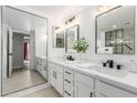 Sleek bathroom showcasing dual vanity sinks and modern fixtures, adjacent to glass enclosed shower at 12222 N Paradise Village S Pkwy # 237, Phoenix, AZ 85032