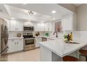 Bright kitchen features modern appliances, white cabinetry, and quartz countertops at 12222 N Paradise Village S Pkwy # 237, Phoenix, AZ 85032