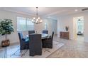 Bright dining room featuring a modern chandelier, rug and a view of the bedroom at 13719 W Amberwing St, Peoria, AZ 85383