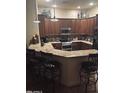Gourmet kitchen featuring granite countertops, breakfast bar, and stainless steel appliances at 14000 N 94Th St # 1077, Scottsdale, AZ 85260