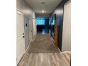 Hallway with hardwood floors and neutral gray walls, leading to the living area with modern décor at 1418 E Jacqueline Pl, Casa Grande, AZ 85122