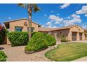 Beautiful landscaping with a mature palm tree accenting the front of this elegant home at 14372 W Cypress St, Goodyear, AZ 85395