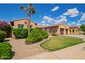 Lovely landscaped front yard with a mature palm tree enhancing the curb appeal of the home at 14372 W Cypress St, Goodyear, AZ 85395