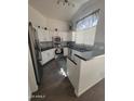 Bright kitchen with white cabinetry, stainless steel appliances, and granite countertops at 14602 S 47Th St, Phoenix, AZ 85044
