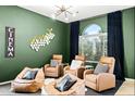 Comfortable seating and a cinema sign create a relaxing atmosphere for movie nights at 14826 N 92Nd Pl, Scottsdale, AZ 85260