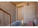 A close up of the front entrance featuring door 103 and a small bench at 151 E Broadway Rd # 103, Tempe, AZ 85282