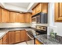 Updated kitchen with stainless steel appliances, granite countertops, and ample cabinet space at 151 E Broadway Rd # 103, Tempe, AZ 85282