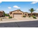 Single-story home featuring a two-car garage and low maintenance desert landscaping at 16412 W Peppertree Ct, Surprise, AZ 85387