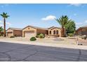 Single-story home featuring a desert landscape with a two-car garage at 16412 W Peppertree Ct, Surprise, AZ 85387