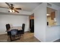 Open dining area with hardwood floors, a modern dining table, and access to kitchen at 17032 N 16Th Dr # 8, Phoenix, AZ 85023