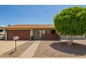 Charming single-story home with a well-manicured xeriscaped yard and inviting front porch at 19031 N 13Th Dr, Phoenix, AZ 85027