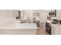Bright kitchen featuring stainless steel appliances and white countertops and cabinets at 1955 Leisure World --, Mesa, AZ 85206