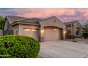 A three-car garage framed by lush green landscaping and a desert-style yard at 1963 E Monterey St, Chandler, AZ 85225