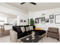 Bright living room boasts shiplap walls, modern decor, and seamless flow to a well-appointed kitchen, perfect for entertaining at 222 E Danbury Rd, Phoenix, AZ 85022