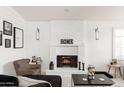 Living room with white brick fireplace, modern decor, and stylish furnishings, creating a comfortable and inviting atmosphere at 222 E Danbury Rd, Phoenix, AZ 85022