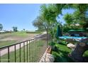 Beautiful backyard with golf course views, turf grass, a pool, and lounge chairs for relaxation under the sun at 22364 N 59Th Ln, Glendale, AZ 85310