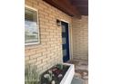 Inviting entryway with a modern blue door, stylish exterior light fixture, and updated landscaping at 224 N 58Th St, Mesa, AZ 85205